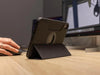 iPad Mini (Gen 6) med robust MAG-skal på skrivbord, stöds av stativ.